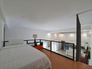 a bedroom with a large bed and a balcony at The Peace House - Siem Reap in Phumĭ Sândăn