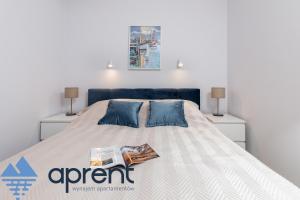 a bedroom with a large bed with two night stands at Apartament MEWA Pobierowo Baltic Apartments - z krytym basenem - Aprent in Pobierowo