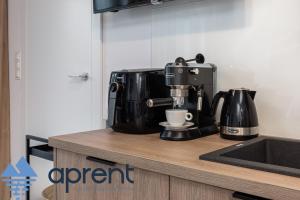 a coffee maker sitting on top of a kitchen counter at Apartament MEWA Pobierowo Baltic Apartments - z krytym basenem - Aprent in Pobierowo