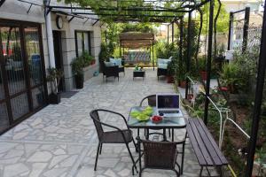 a patio with a table with a laptop on it at Deluxe Aquamarine in Ahtopol