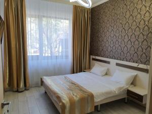 a bedroom with a bed and a large window at Lotus 7 Silver in Mamaia +43 photos