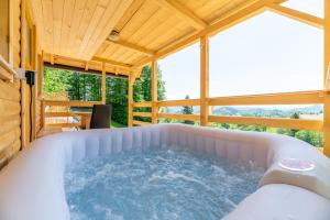 a jacuzzi tub in a tiny house at Glamping Laze in Gorenja Vas