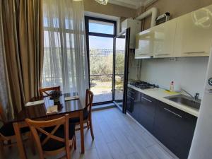 a kitchen with a table and a kitchen with a window at Lotus 7 Silver in Mamaia