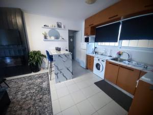 a kitchen with a sink and a washing machine at Casa Di Penny in Kyparissia