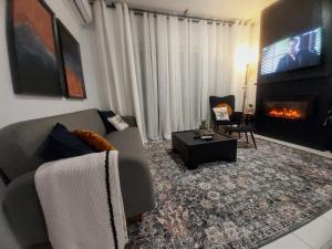 a living room with a couch and a fireplace at Casa Di Penny 2 in Kyparissia