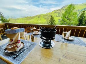a table with shoes and a pot on a balcony at Chalet Edelweiss in Moleson
