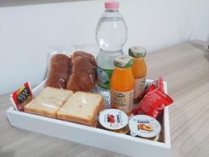 a lunch box with cheese bread and bottles of drinks at Scirocco Guest House in Brindisi