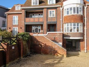 a brick house with a staircase in front of it at Ocean Watch 5 in Weymouth