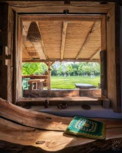 a window in a log cabin looking out at a park at Conacu Iancu in Ginta