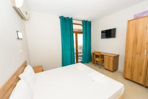 ソゾポルにあるGarden Beach Luxurios Apartment A9のベッドルーム(ベッド1台、デスク、テレビ付)