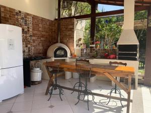 a kitchen with a wooden table and a stove at Cantinho na Serra in Teresópolis