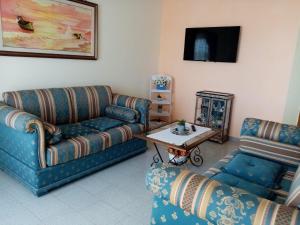 a living room with two couches and a table at Le stanze di Botticelli in Termoli