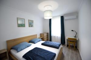 A bed or beds in a room at Best Apartman Lelle