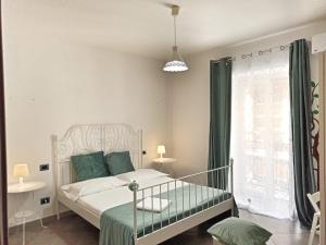 a bedroom with a white bed and a window at Hello World in Agrigento