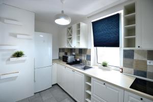 A kitchen or kitchenette at Best Apartman Lelle