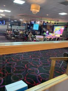 a lobby with a carpeted floor and a bar at Cosy Private Caravan Romney Sands Holiday Park in New Romney