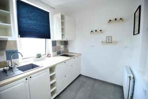 A kitchen or kitchenette at Best Apartman Lelle