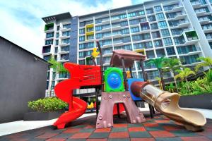a playground in front of a large building at Lovely Jazz 1 3bedrooms with 2 Card LV9 in Kuching