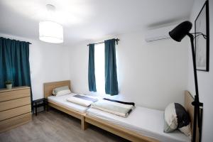 A bed or beds in a room at Best Apartman Lelle