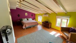 a bedroom with a bed and colorful walls at Finca La Higuera - Boutique B&B in Ontinyent