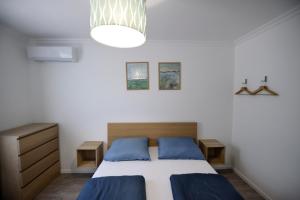 A bed or beds in a room at Best Apartman Lelle