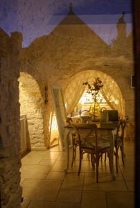 a dining room with a table and chairs at EnjoyTrulli - Unesco Site in Alberobello