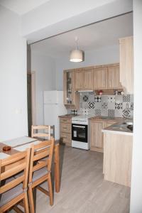 a kitchen with wooden cabinets and a table and chairs at Nemo 2 in Xi