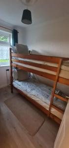 a wooden bunk bed in a room with a window at Isle of Wight Chalet in Sandown