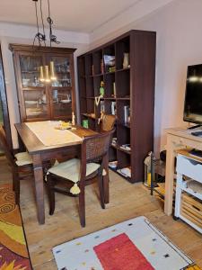 a dining room with a wooden table and chairs at Privatzimmer im Gasthaus Engel in Dornbirn