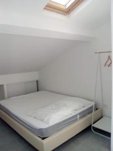 a bed in a white room with a swing at 3P Masséna Old Nice last stage in Nice