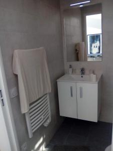 a bathroom with a white sink and a mirror at 3P Masséna Old Nice last stage in Nice