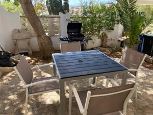 a blue table and chairs in a yard at Villa Dacla in Lampedusa