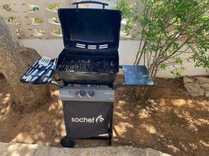 a barbecue grill with a trash can next to it at Villa Dacla in Lampedusa
