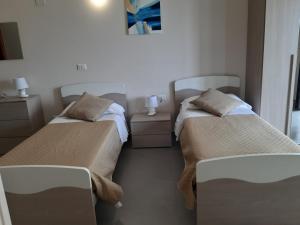 A bed or beds in a room at Un passo dal mare - Guest House