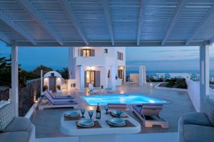 a villa with a swimming pool on a patio at Hemera Holiday Home villa on Santorini in Akrotiri