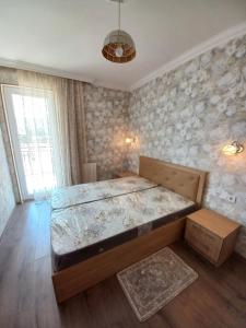 a bedroom with a large bed in a room at The Yellow Brick Apartment in Tbilisi City