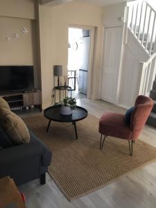 a living room with a couch and a table at Shoemakers Cottage in Ramsgate +53 photos