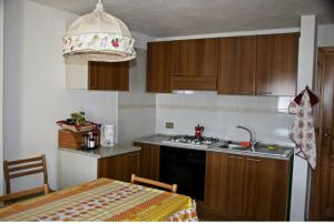 a kitchen with a sink and a stove top oven at STOP & STARE STARS in Lignan