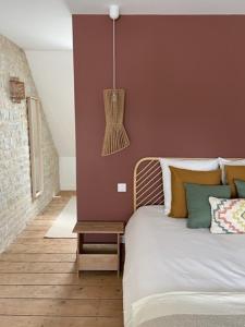 a bedroom with a bed with a table next to it at La suite in Sainte-Mère-Église