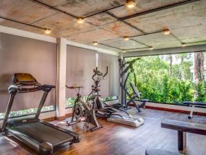 a gym with several exercise bikes in a room at The Title Rawai: Beachfront condotel in Rawai Beach