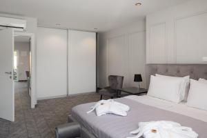 a hotel room with a bed with towels on it at Zlatni Rat Beach Resort in Bol