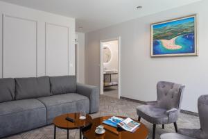 a living room with a couch and a table at Zlatni Rat Beach Resort in Bol