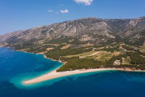 an aerial view of an island in the ocean at Zlatni Rat Beach Resort in Bol
