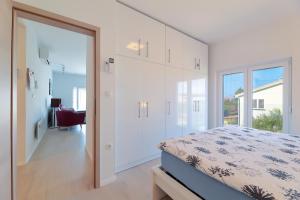 a bedroom with a bed and a sliding glass door at Apartment Alan 3 in Vrsi +39 photos