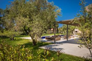 a picnic shelter in a park with trees at Villa JOYANA in Svoronata