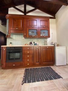 a kitchen with wooden cabinets and a refrigerator at Katouna hill in Lefkada Town
