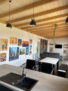 a kitchen with a sink and a table with chairs at Haus am See in Calden