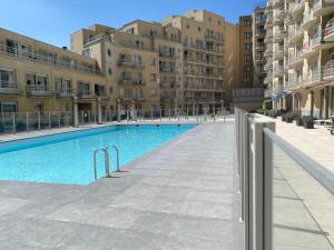 a large swimming pool in the middle of a building at Deluxe Apartment with Shared Pool in Ostend