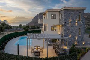 a villa with a swimming pool and a house at Utopia Luxury Villas in Gouves