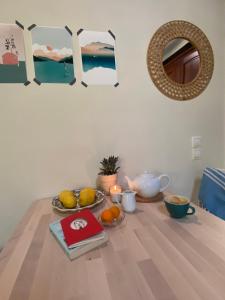 a table with a plate of fruit and a mirror at Katouna hill in Lefkada Town